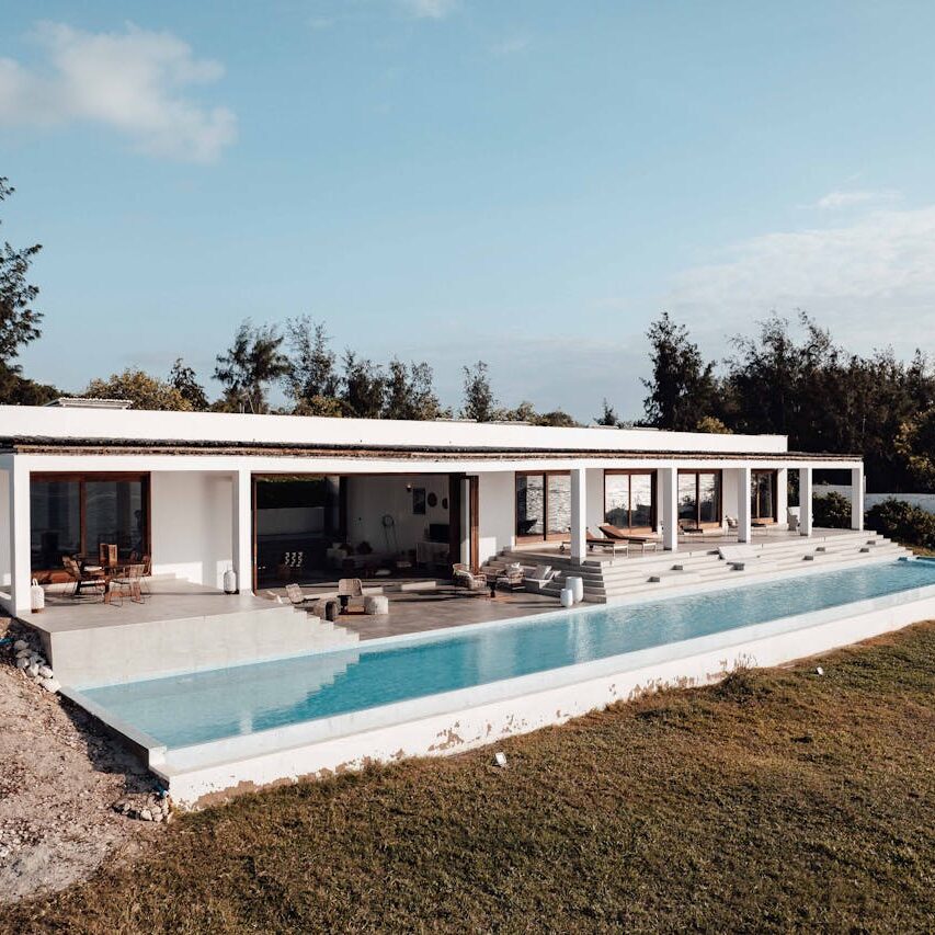 Elegant villa with an infinity pool set in a serene outdoor landscape.